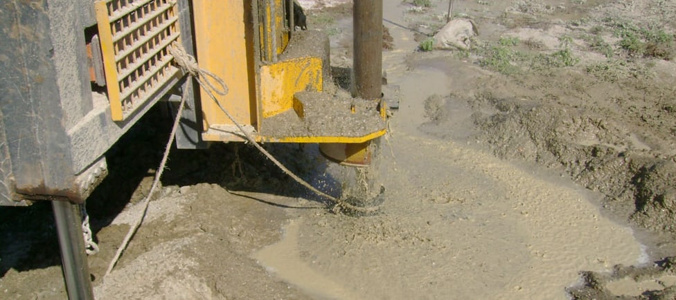 Water rising from a freshly drilled borehole at the drill head