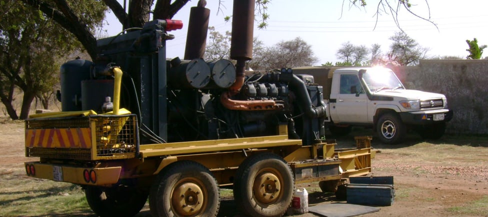 High-pressure compressor trailer used for borehole drilling